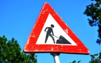 close up photography of red and white road signage