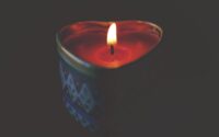 close up of tea light candle against black background