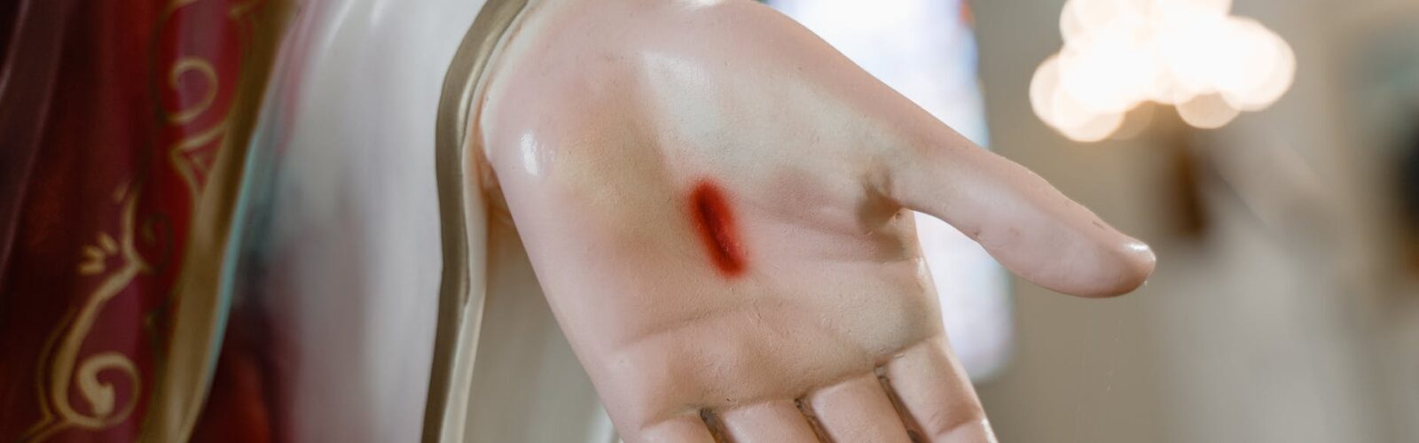 person in red long sleeve shirt holding womans hand