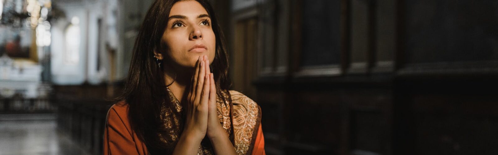 a woman praying inside the church