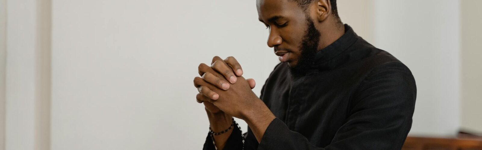 a religious man praying solemnly