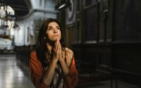 a woman praying inside the church