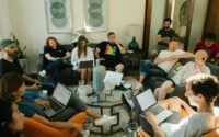 group of people sitting on sofa while discussing