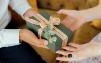 person giving a gift box