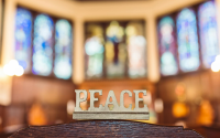 peace word carved in wood
