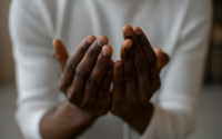crop black man praying at home