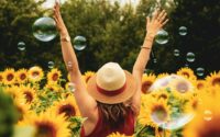 woman surrounded by sunflowers