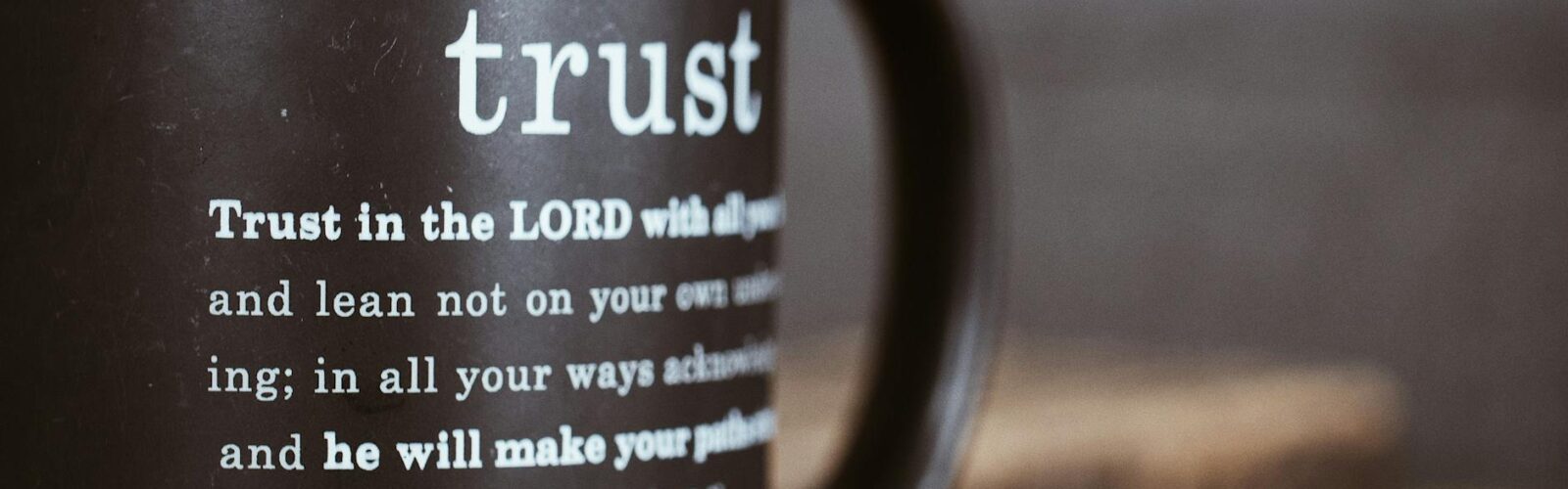 black mug with proverb from holy bible