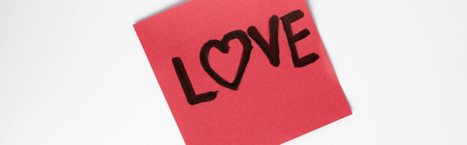 red love note with heart on white background