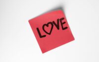 red love note with heart on white background