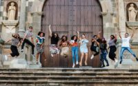group of young people jumping in the air at the church steps