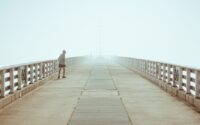 man walking on a pier
