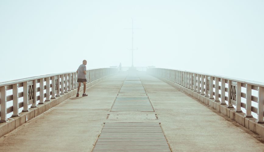 man walking on a pier